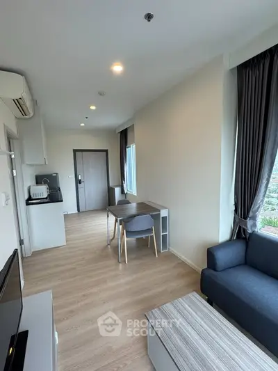 Modern living room with sleek furniture and natural light, perfect for urban living.