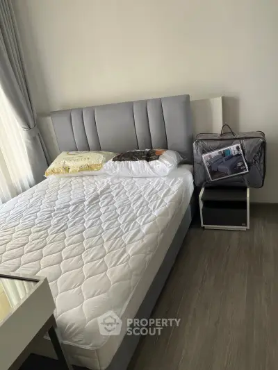 Modern bedroom with stylish bed and sleek flooring, perfect for a cozy retreat.