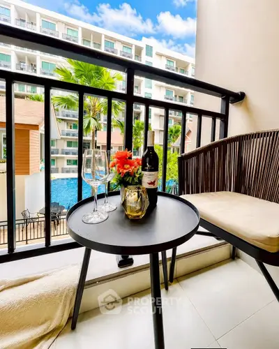Charming balcony with pool view, perfect for relaxation and entertaining guests.