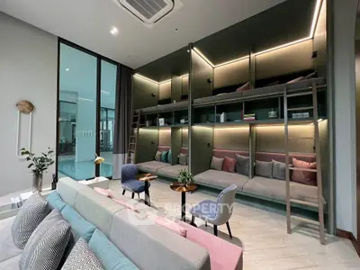Modern living room with stylish seating and built-in shelving, perfect for relaxation and entertainment.