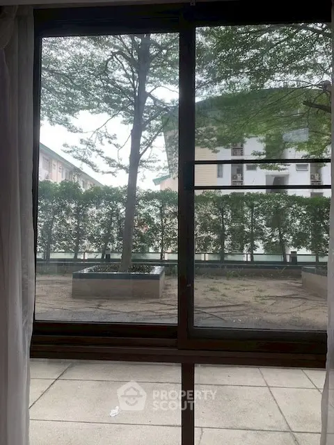 Spacious apartment view with lush greenery and modern architecture, perfect for serene living.