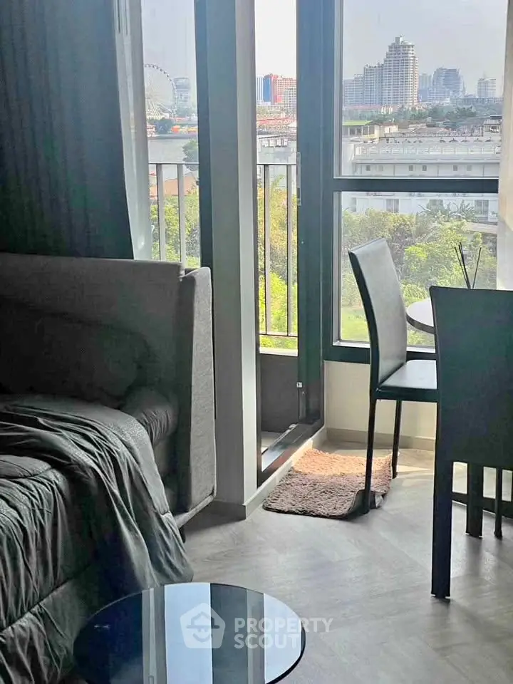 Modern apartment with city view, featuring cozy living area and dining space near large windows.