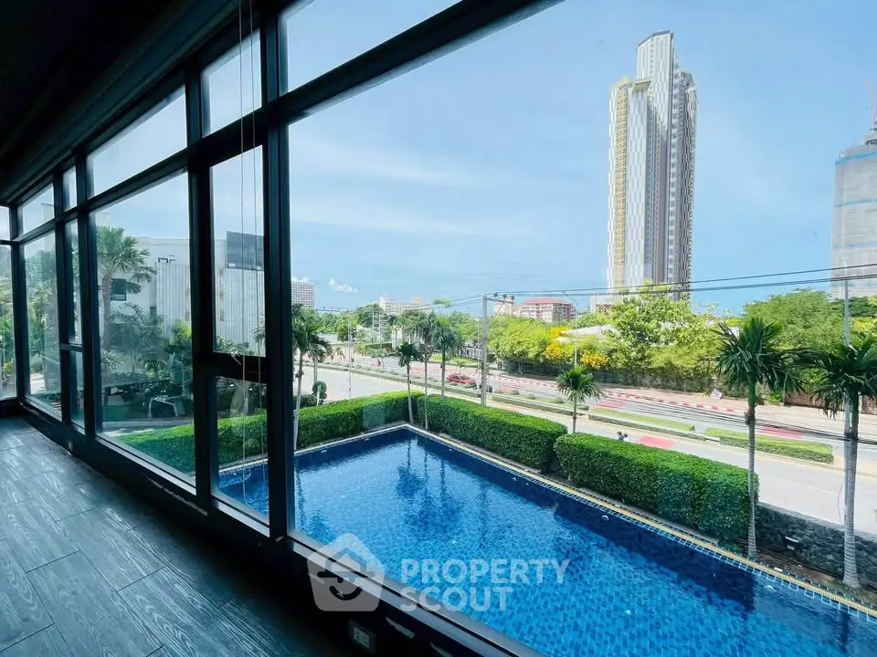 Stunning high-rise view with pool and lush greenery, perfect for luxury living.