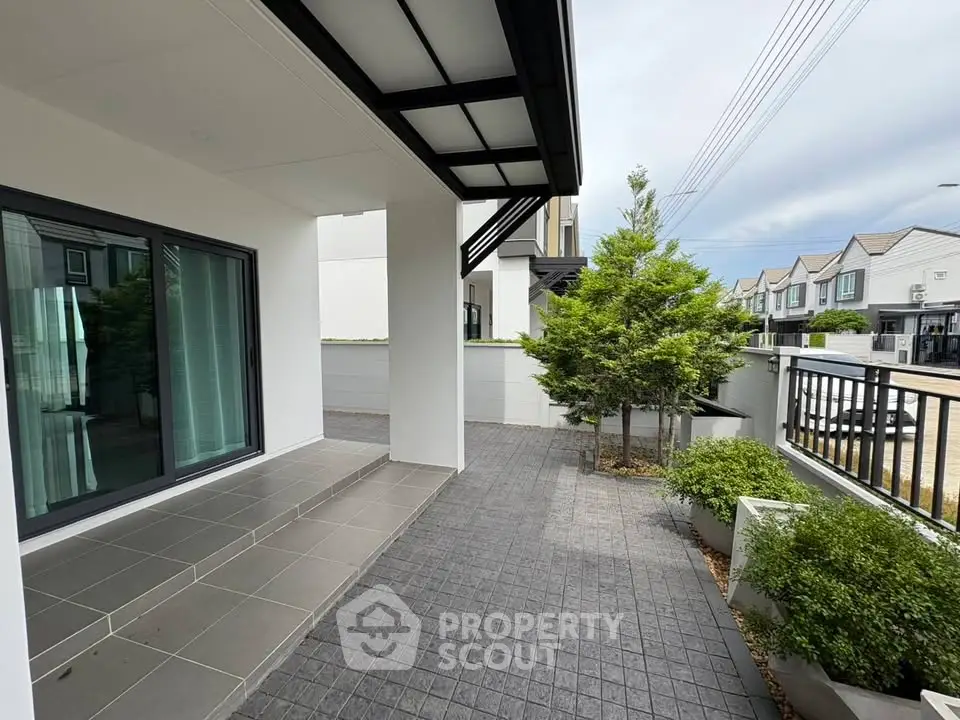 Modern townhouse exterior with sleek design and private garden area.