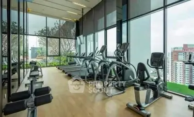 Modern gym with panoramic city views and state-of-the-art fitness equipment.