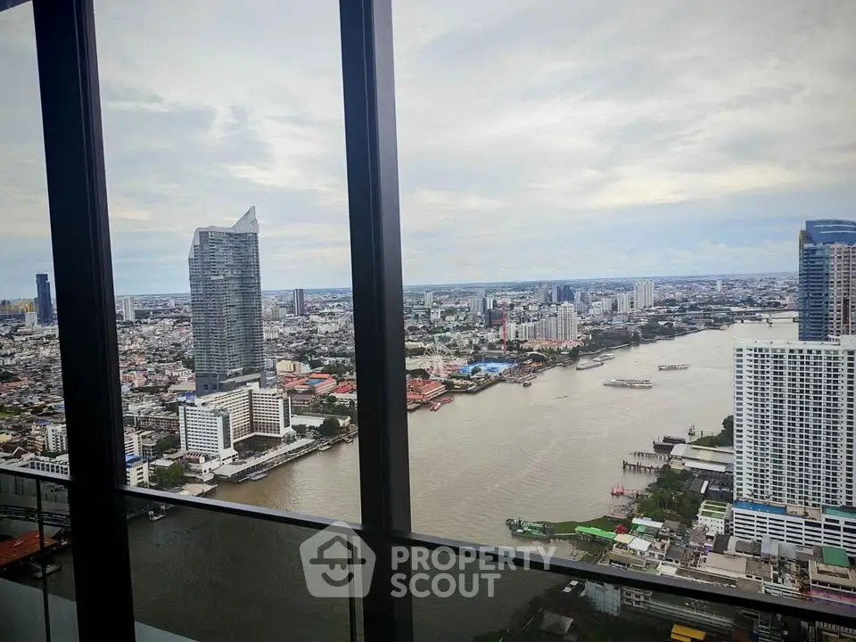 Stunning high-rise river view from a modern apartment balcony in the city.