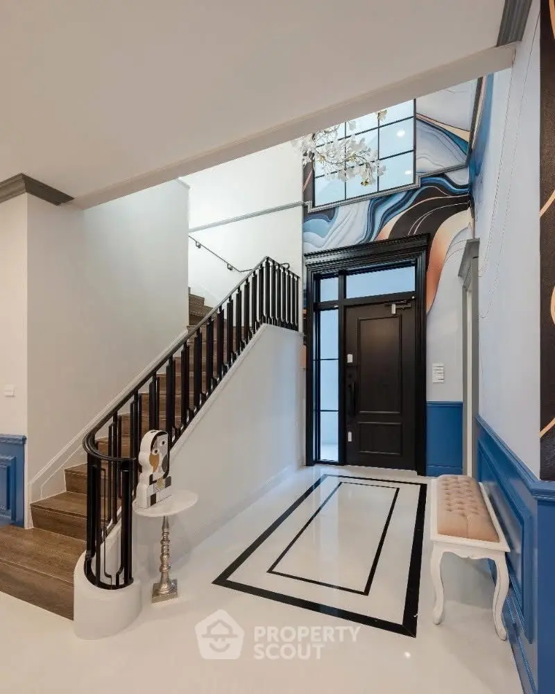 Elegant entrance with modern staircase and stylish decor
