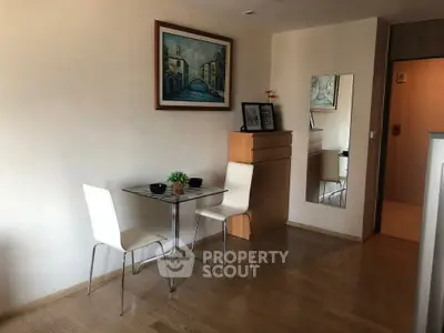 Cozy dining area with modern decor and wooden flooring in a stylish apartment.