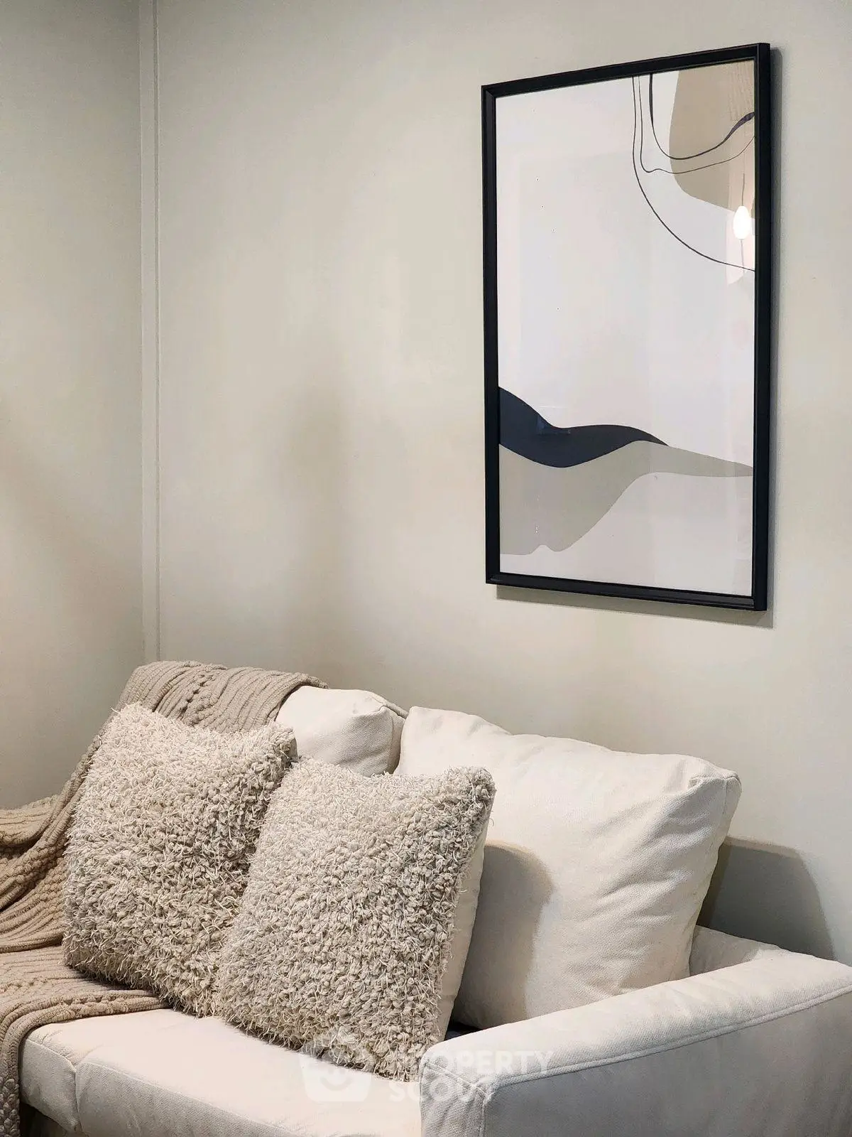 Cozy living room with stylish sofa and modern abstract art on the wall.