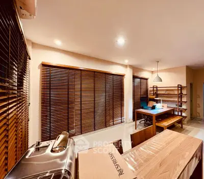 Spacious modern living room with wooden blinds and stylish furniture