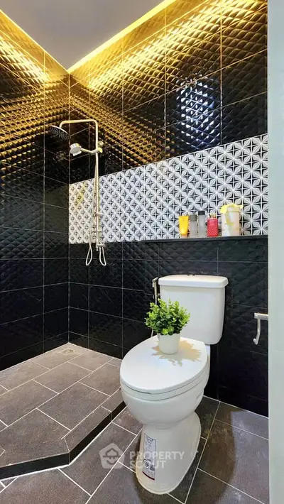 Modern bathroom with stylish black tiles and contemporary fixtures