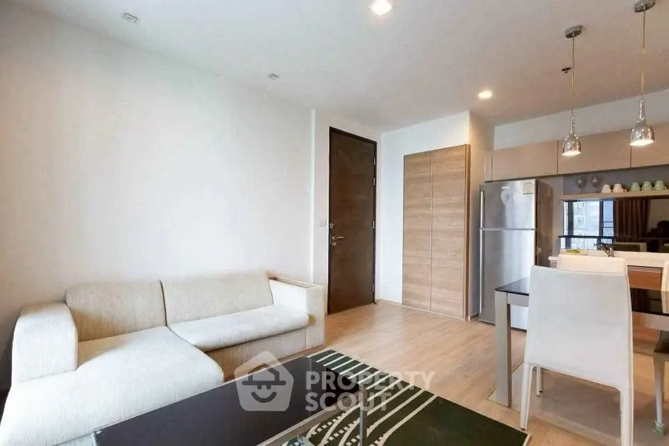 Modern living room with open kitchen and stylish furniture in a cozy apartment.