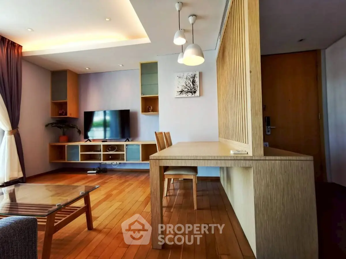 Spacious living room with modern wooden furniture and elegant lighting