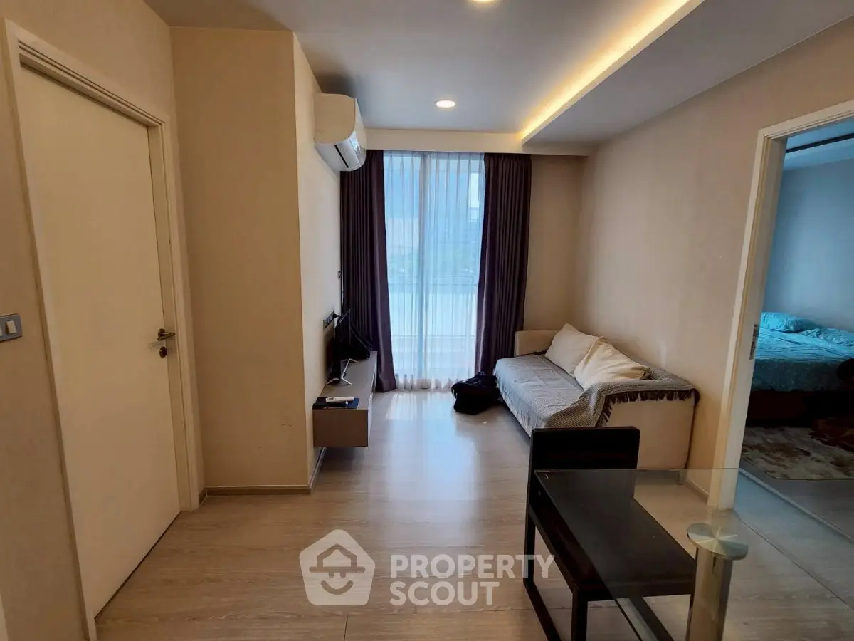 Modern living room with sleek design and cozy ambiance, featuring a comfortable sofa and stylish decor.