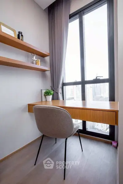 Modern study nook with large window and city view, featuring sleek desk and stylish chair.