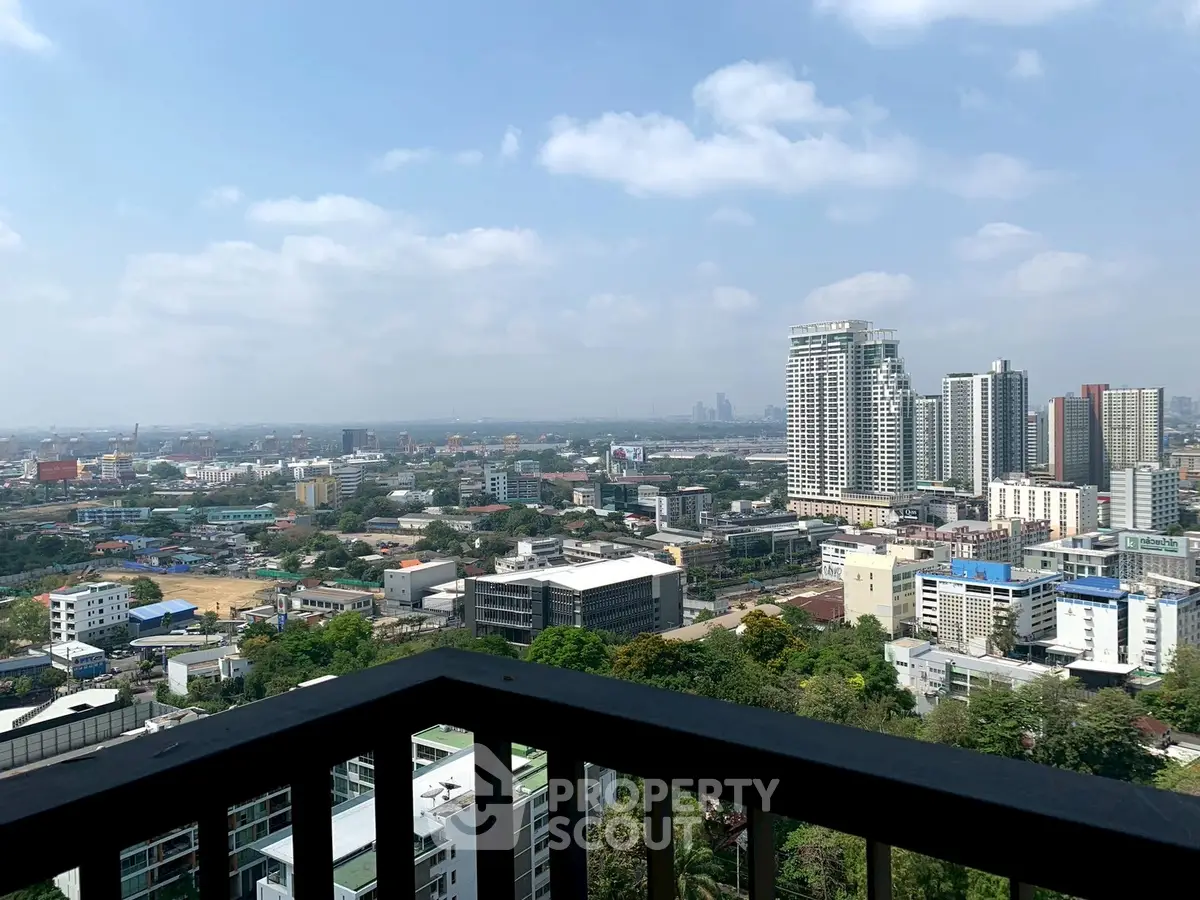 Stunning cityscape view from a high-rise balcony overlooking urban skyline.