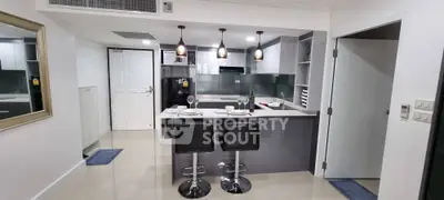 Modern kitchen with sleek design and breakfast bar seating