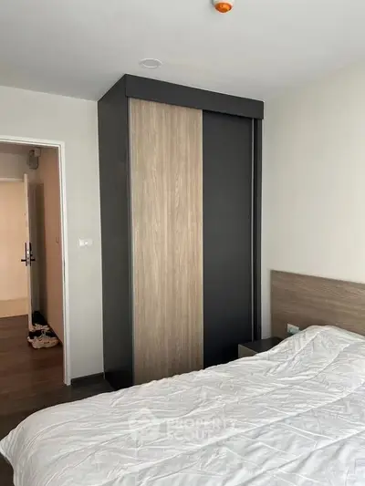 Modern bedroom with sleek wardrobe and cozy bed in minimalist design.