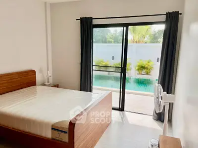 Spacious bedroom with pool view and modern furnishings in a luxury home.