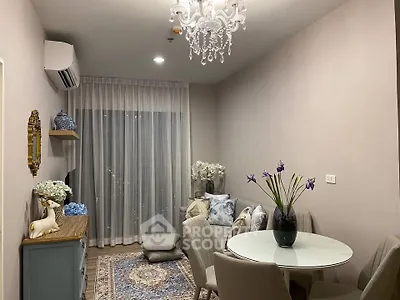 Elegant living room with chandelier, cozy seating, and stylish decor