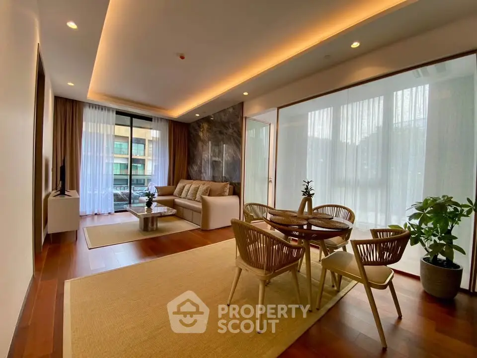 Spacious modern living room with elegant decor and large windows in a luxury apartment.