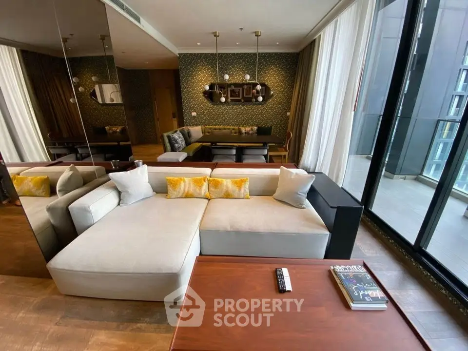 Luxurious living room with modern decor and spacious balcony view.