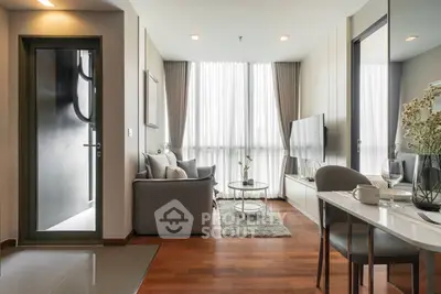 Modern living room with stylish decor and large windows in a contemporary apartment.