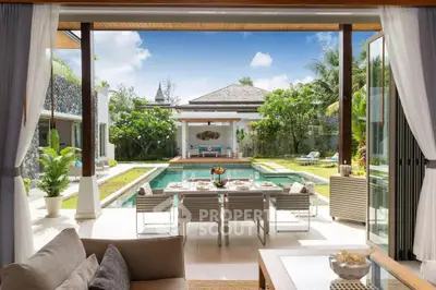 Luxurious open-plan living area with pool view in tropical villa