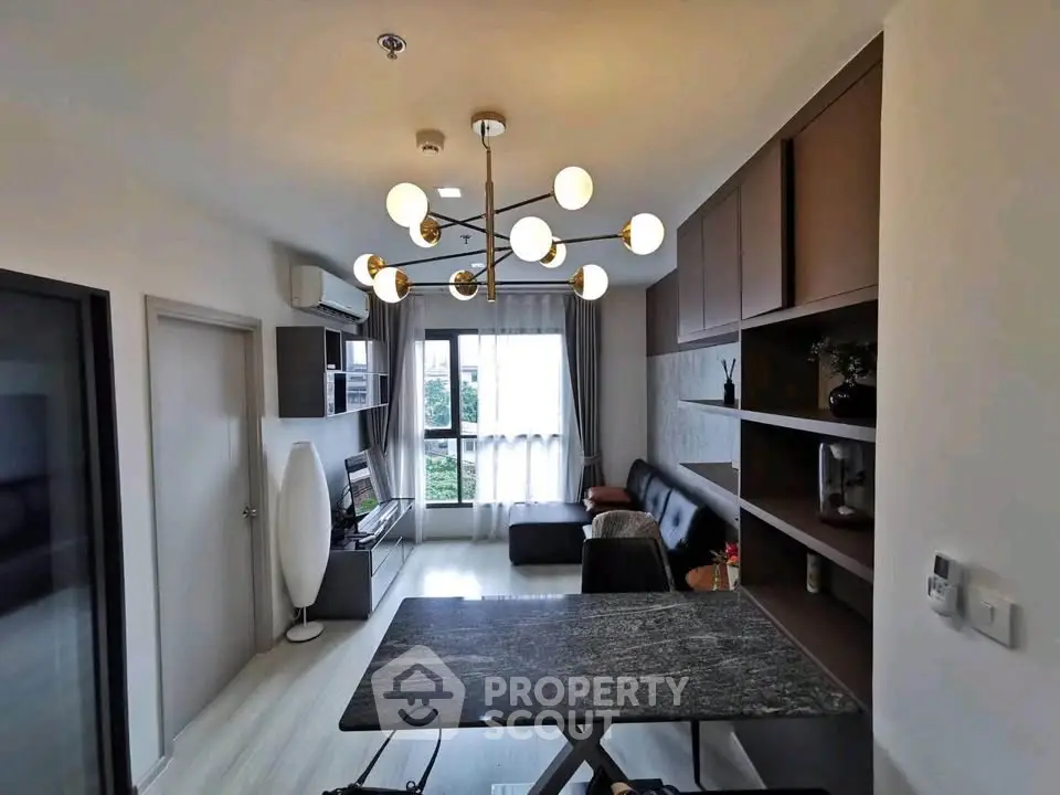 Modern living room with stylish lighting and sleek furniture in a contemporary apartment.