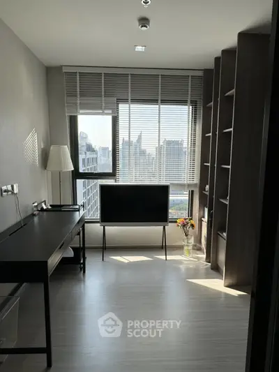 Modern study room with city view, sleek desk, and ample shelving in a high-rise apartment.