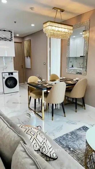 Luxurious modern dining area with elegant chandelier and washing machine in stylish apartment.
