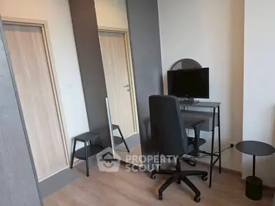 Modern study room with sleek desk, chair, and large mirror in stylish apartment.