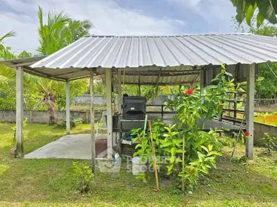 Charming outdoor gazebo with lush greenery, perfect for relaxation and gatherings in a serene garden setting.