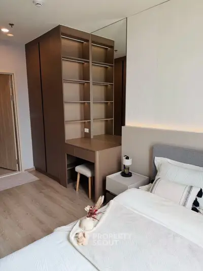 Modern bedroom with built-in shelving and cozy decor