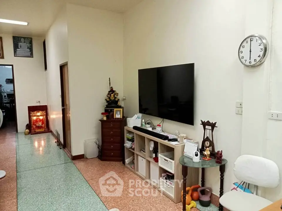 Spacious living room with modern TV setup and stylish decor