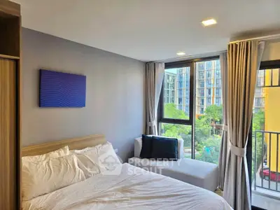 Modern bedroom with large window and scenic view in urban apartment