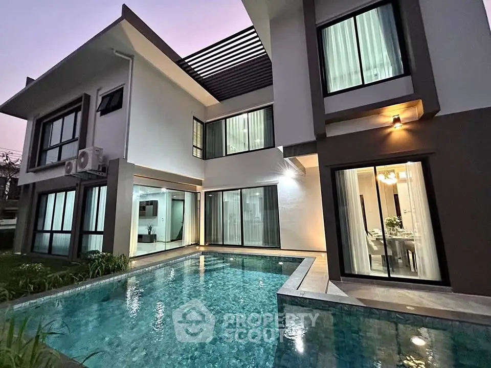Luxurious modern home with stunning pool and elegant architecture at dusk