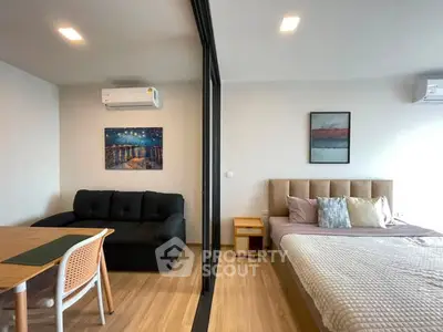 Modern studio apartment with stylish decor and open layout, featuring a cozy living area and comfortable bed.