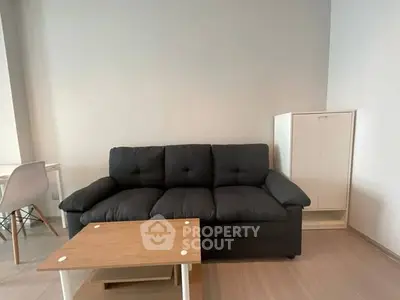 Modern living room with stylish black sofa and wooden coffee table