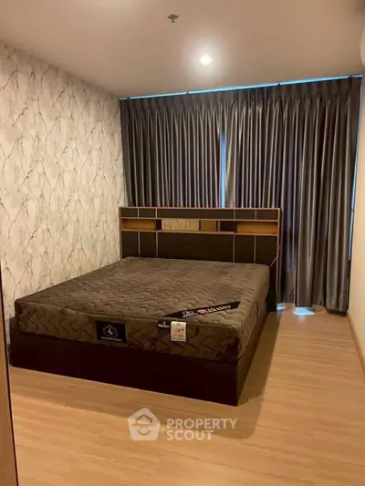 Modern bedroom with stylish bed and elegant curtains in a cozy apartment.