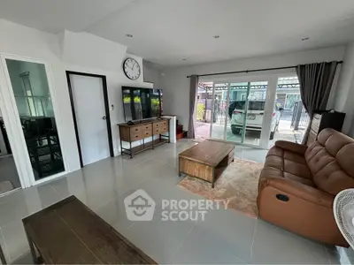 Spacious living room with modern furniture and large windows for natural light.