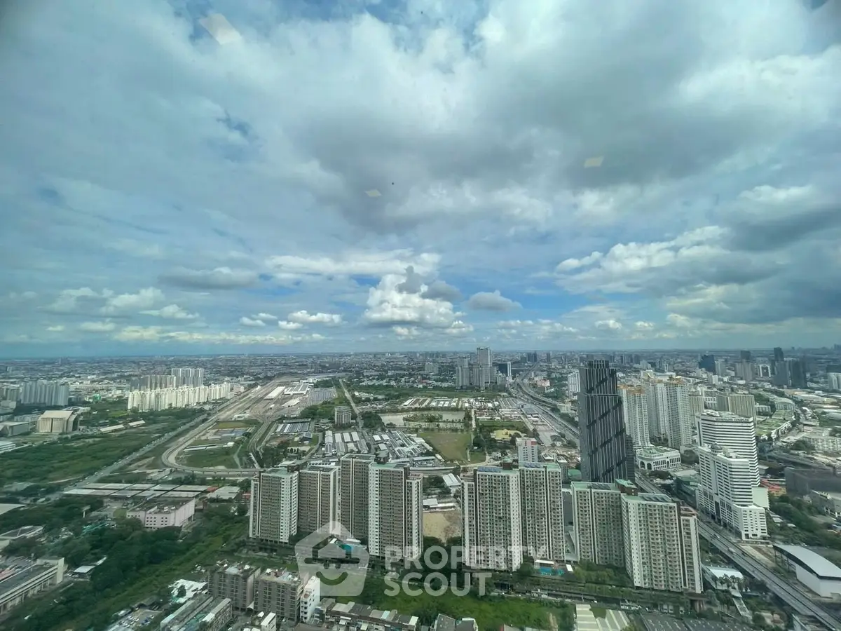 Stunning panoramic cityscape view from high-rise building, showcasing urban skyline and expansive sky.