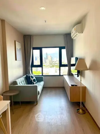 Modern living room with city view, featuring a cozy sofa and sleek decor in a high-rise apartment.