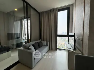 Modern living room with city view, featuring sleek furniture and floor-to-ceiling windows.