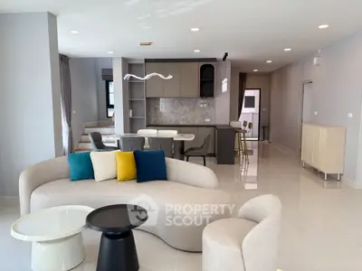 Modern open-plan living room with stylish furniture and sleek kitchen design