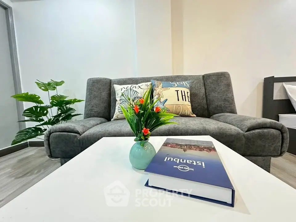 Modern living room with stylish gray sofa and vibrant decor accents