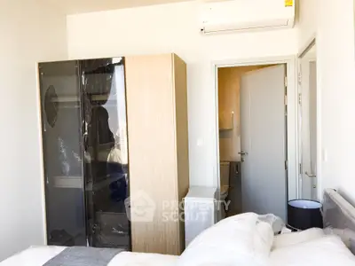 Cozy bedroom with modern wardrobe and air conditioning unit