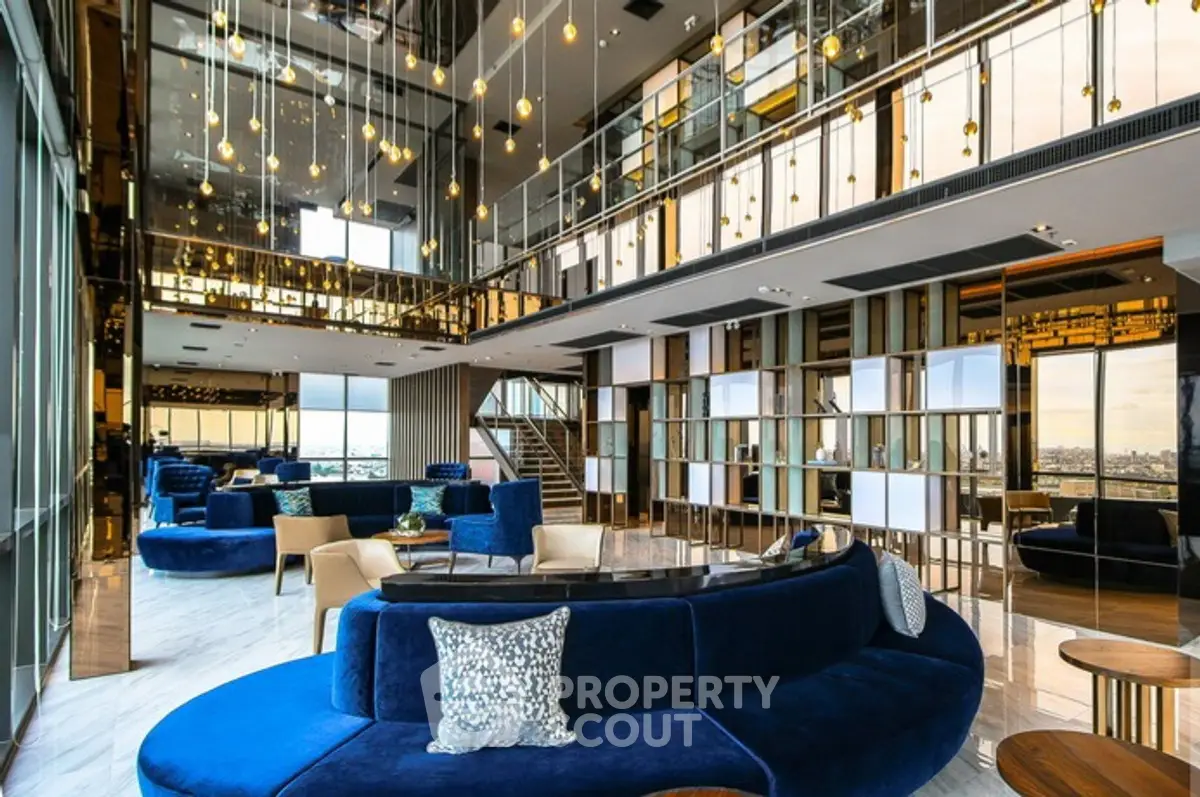 Luxurious modern living room with panoramic city views and elegant blue seating