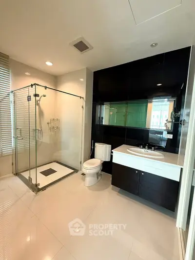 Modern bathroom with glass shower and sleek black and white design