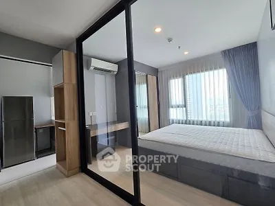 Modern bedroom with glass partition and natural light in stylish apartment